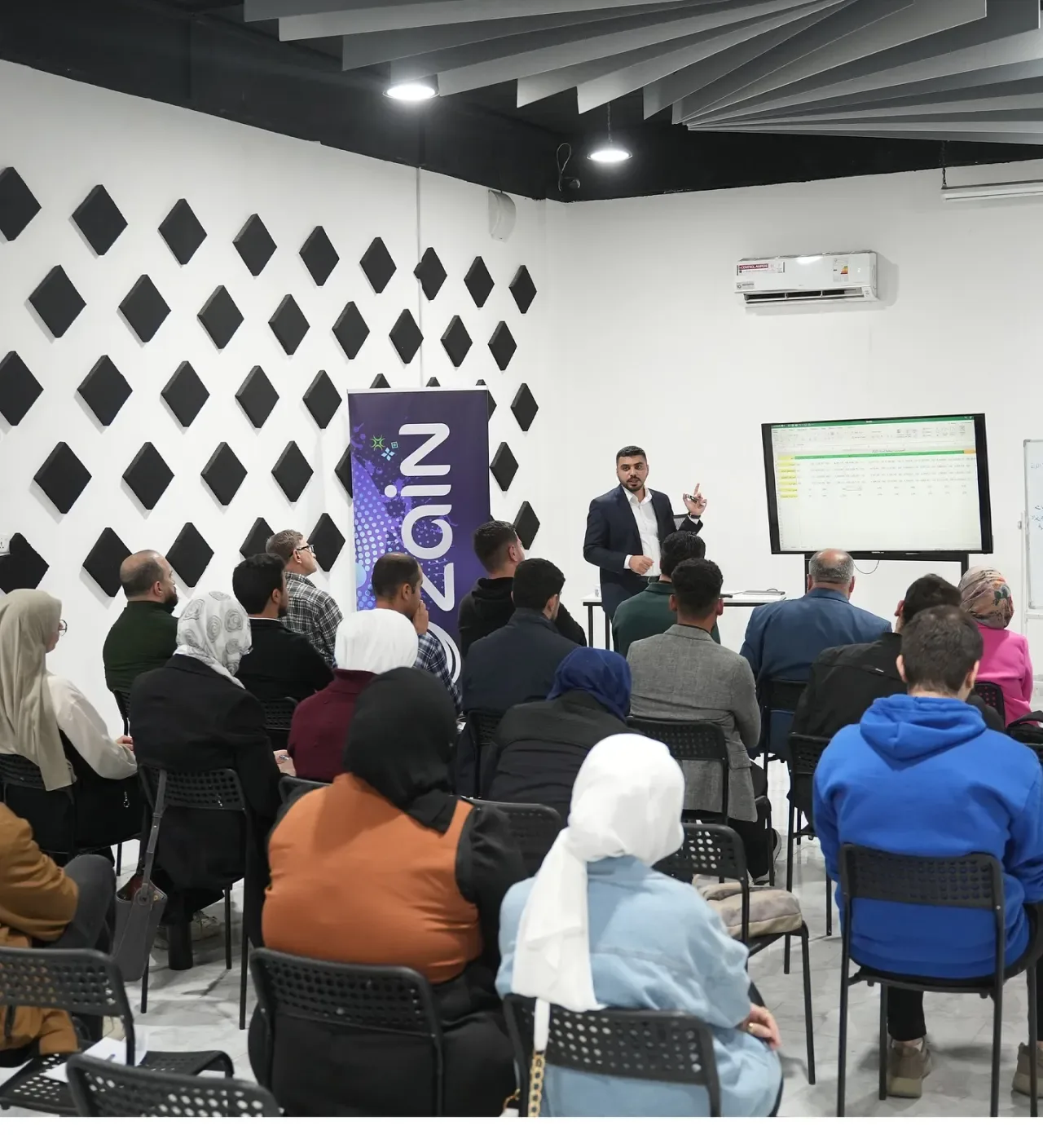 Audience at Mosul Space listening to a speaker during the session on investment and attracting investors